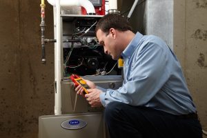 HVAC technician inspecting a heating system