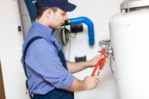 Technician repairing a water heater