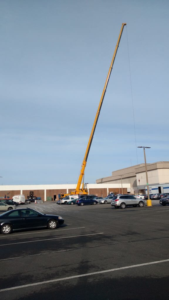 Crane lifting commercial HVAC equipment