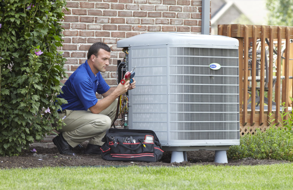 Technician performing air conditioning maintenance