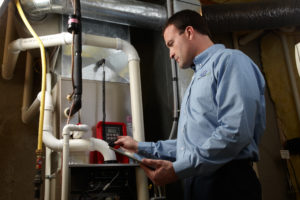technician performing heating system maintenance