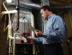 hvac technician checks furnace