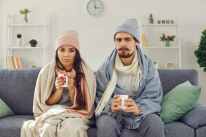 couple at home in cold house with winter wear 