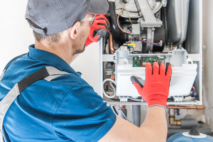 HVAC technician repairing a system