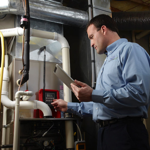 hvac technician checks furnace